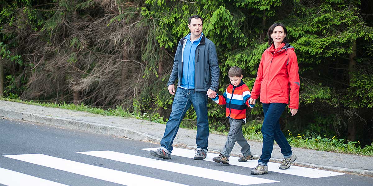 Family crossing the road