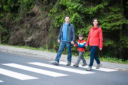 Family crossing the street